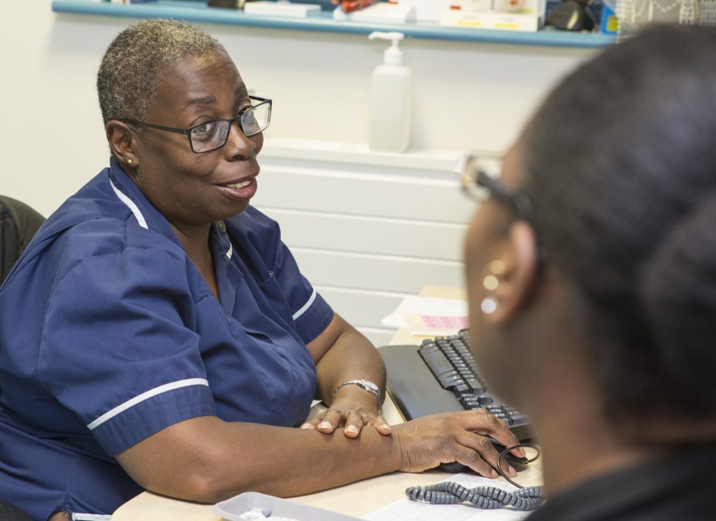 A Queen’s nurse in a GP Practice with a patient