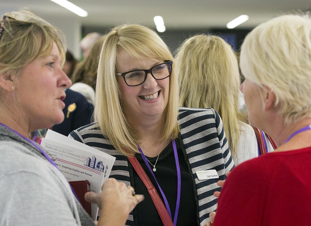 A group of QNI delegates chat