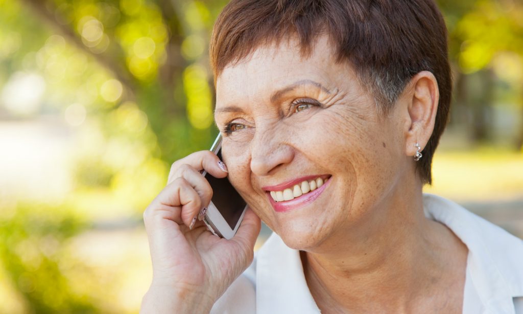 Older woman talks on a mobile phone
