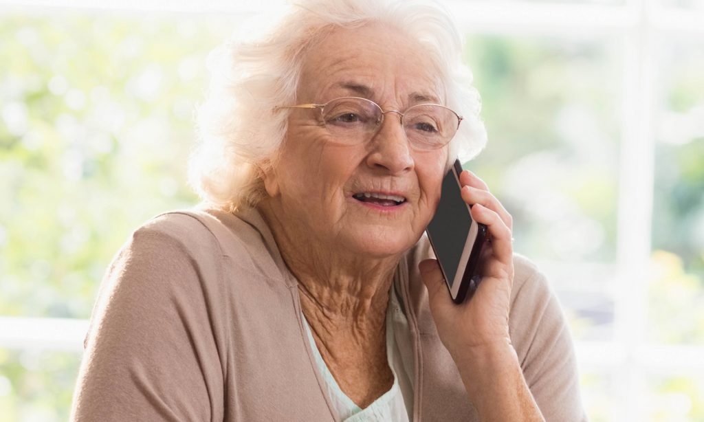 An elderly lady using a mobile phone