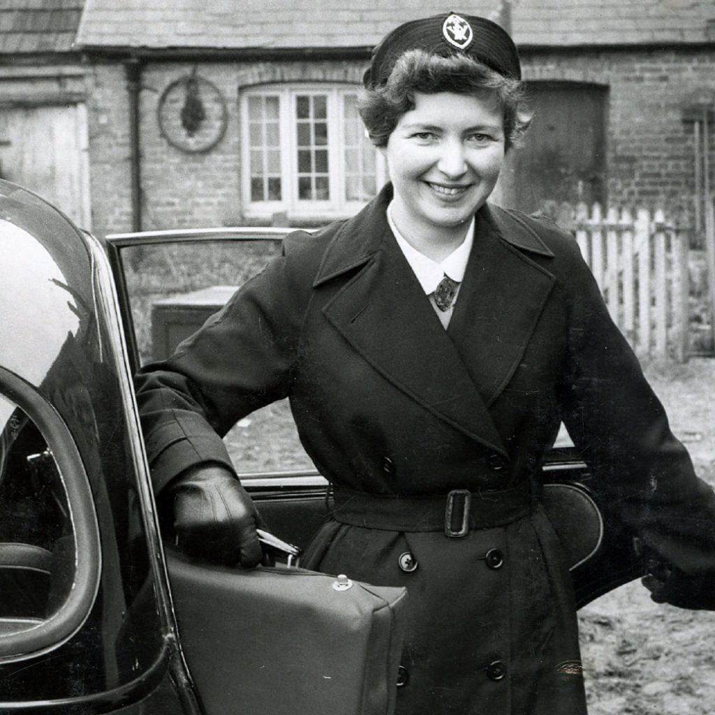 Mid 20c district nurse with her car