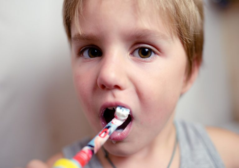 Boy brushes his teeth – The Queen's Nursing Institute