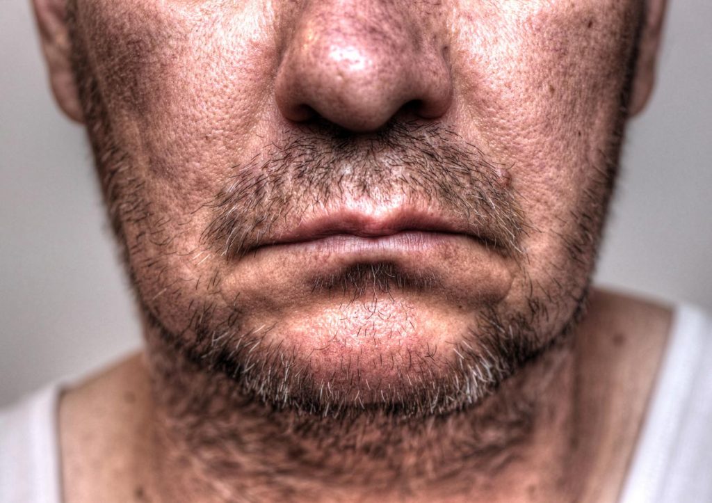 Close up view of a serious man with stubble