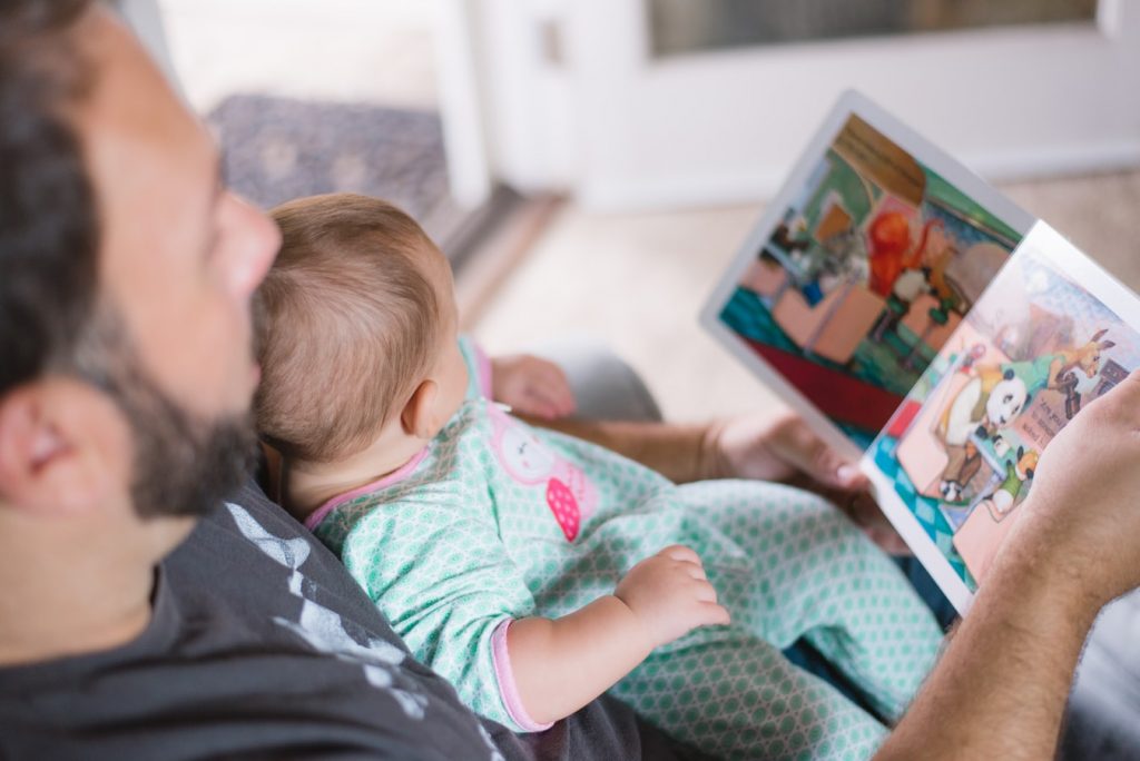 Dad reading a story to a baby