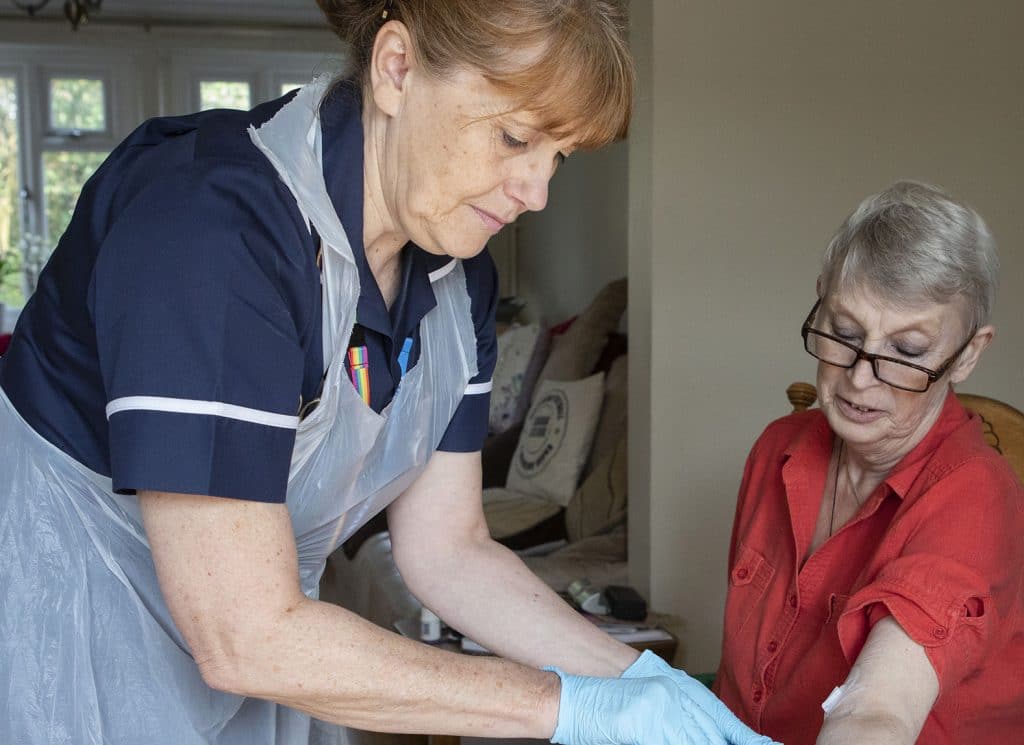Queen's Nurse Liz Alderton with a patient