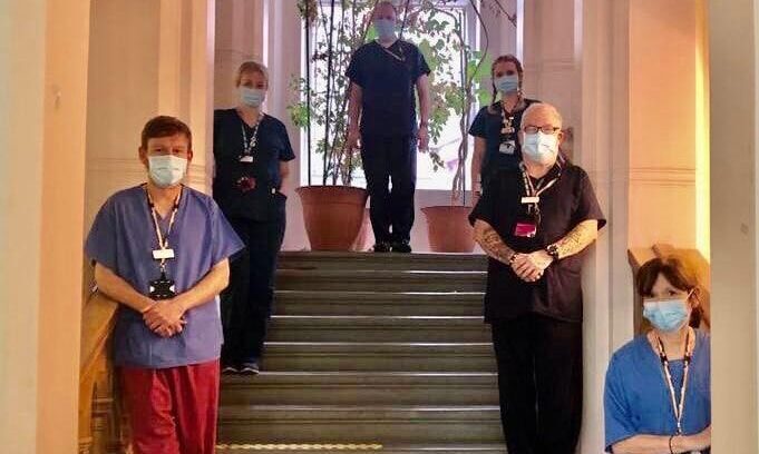 Health staff standing on staircase in masks