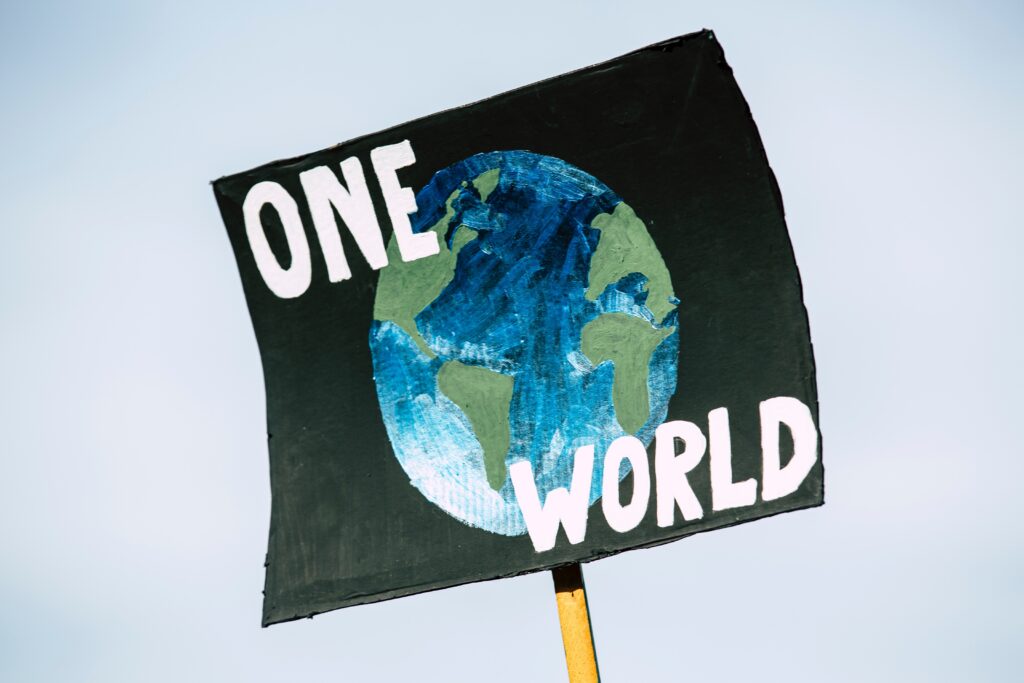 Banner with a planet painted on it saying 'One World'